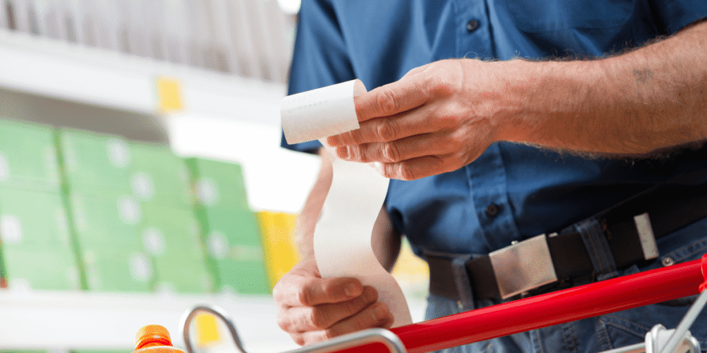 Person reviewing their grocery receipt.